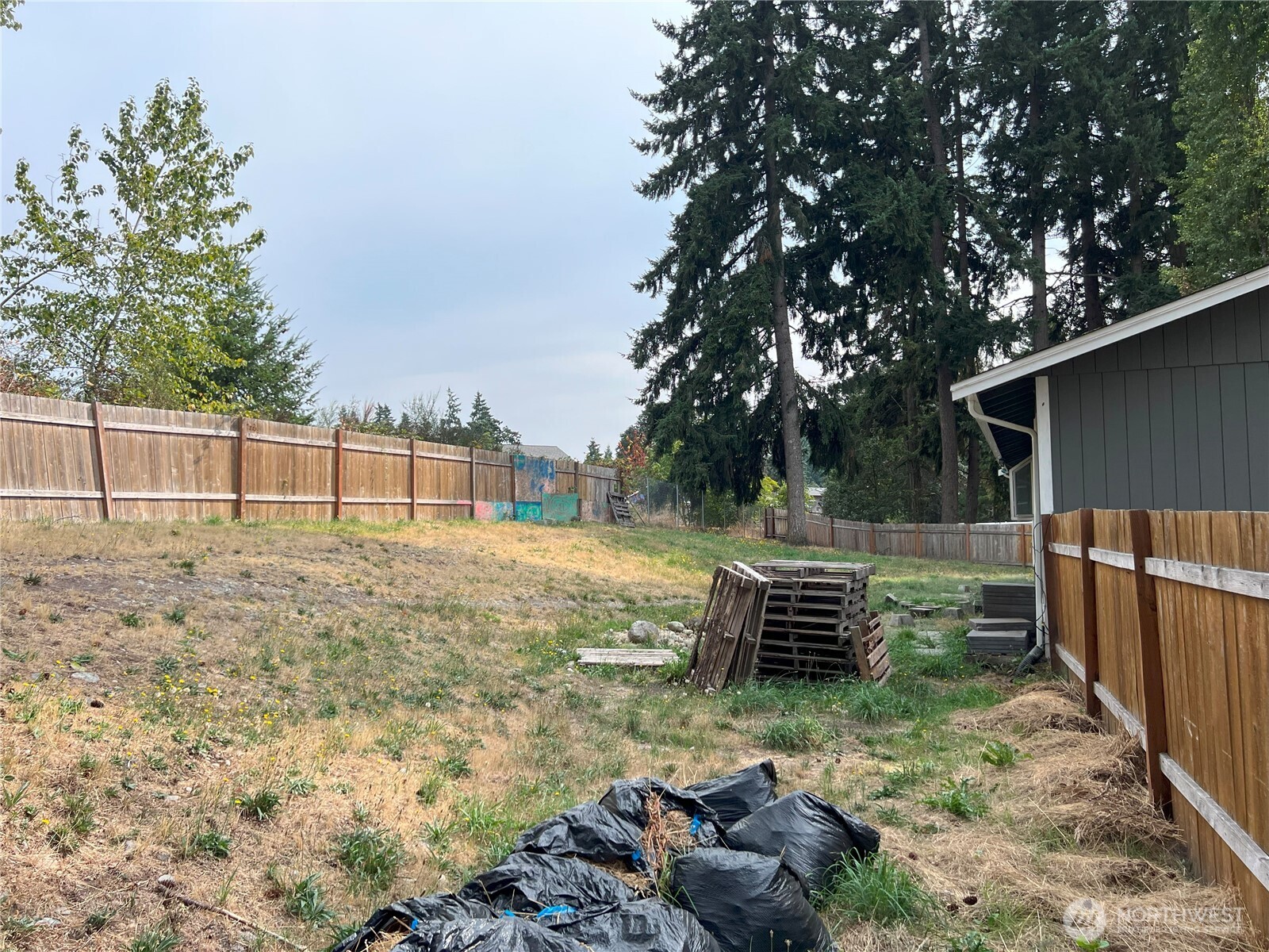511 190th Street East Spanaway, WA 98387 - Photo 27 of 33 a view of a yard with wooden fence