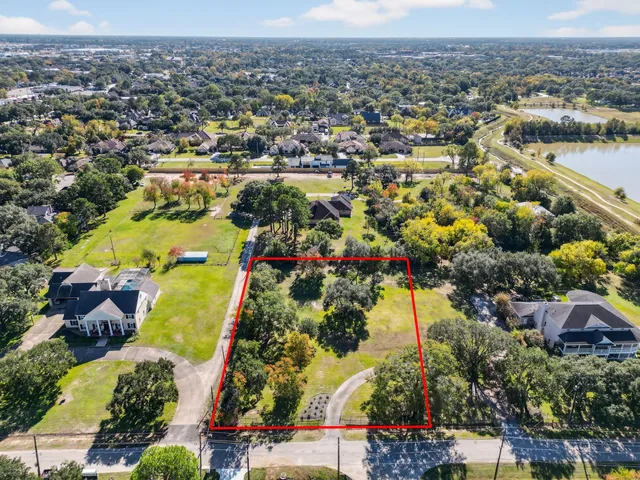 an aerial view of residential building and lake