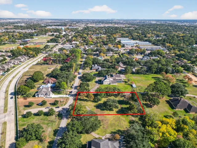 an aerial view of residential houses with outdoor space and swimming pool