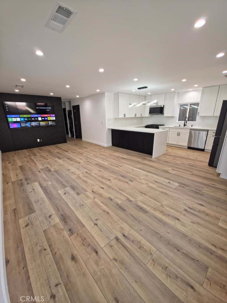 7045 Nestle Avenue Reseda, CA 91335 - Photo 2 of 15 a view of kitchen and hall with wooden floor