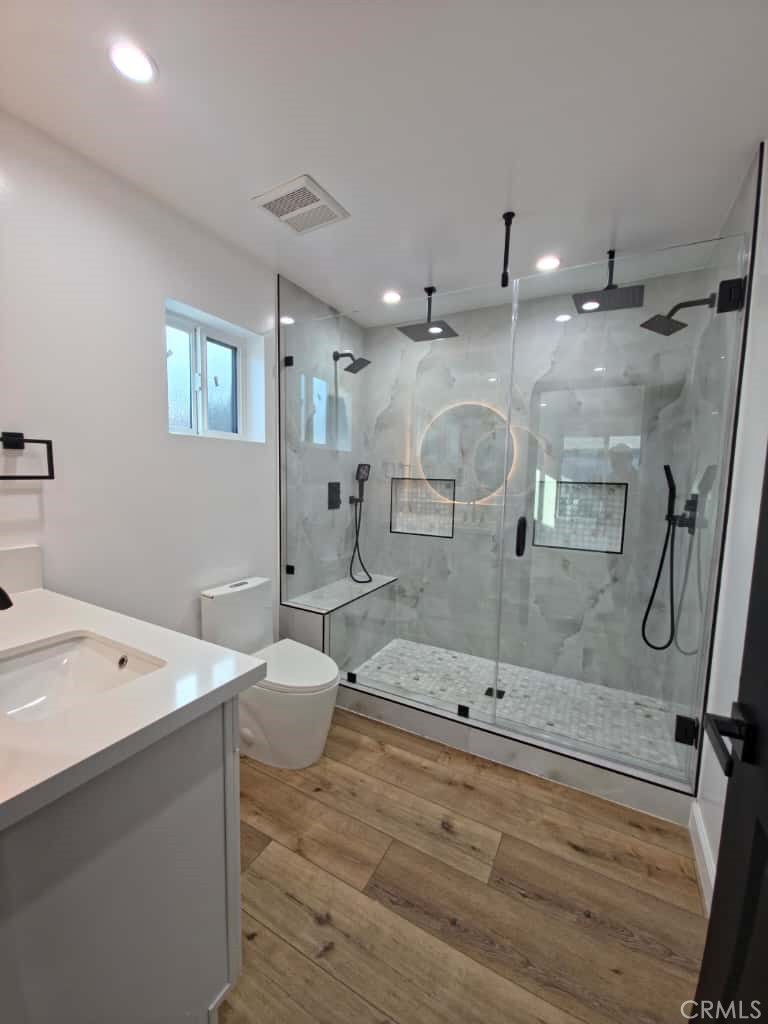 7045 Nestle Avenue Reseda, CA 91335 - Photo 4 of 15 a bathroom with a tub sink mirror and shower
