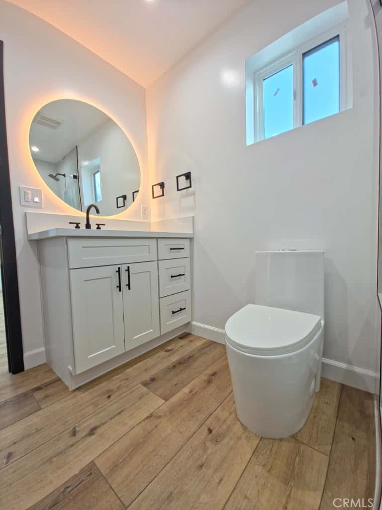 7045 Nestle Avenue Reseda, CA 91335 - Photo 5 of 15 a spacious bathroom with a toilet sink and mirror