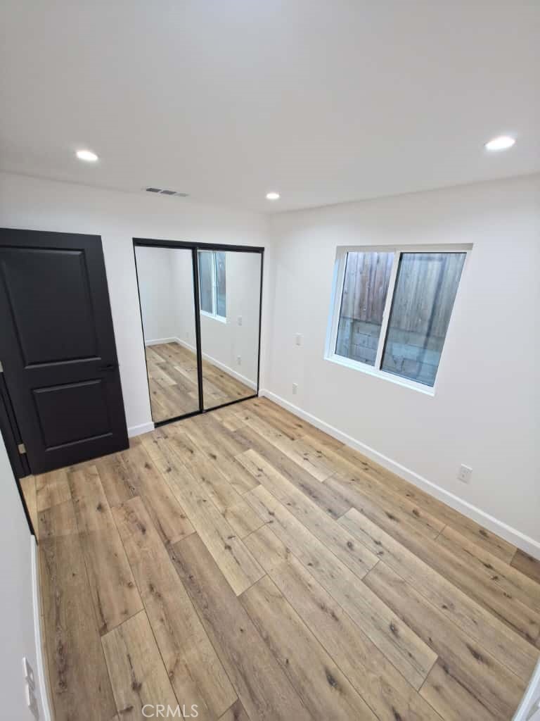 7045 Nestle Avenue Reseda, CA 91335 - Photo 6 of 15 a view of empty room with wooden floor and window