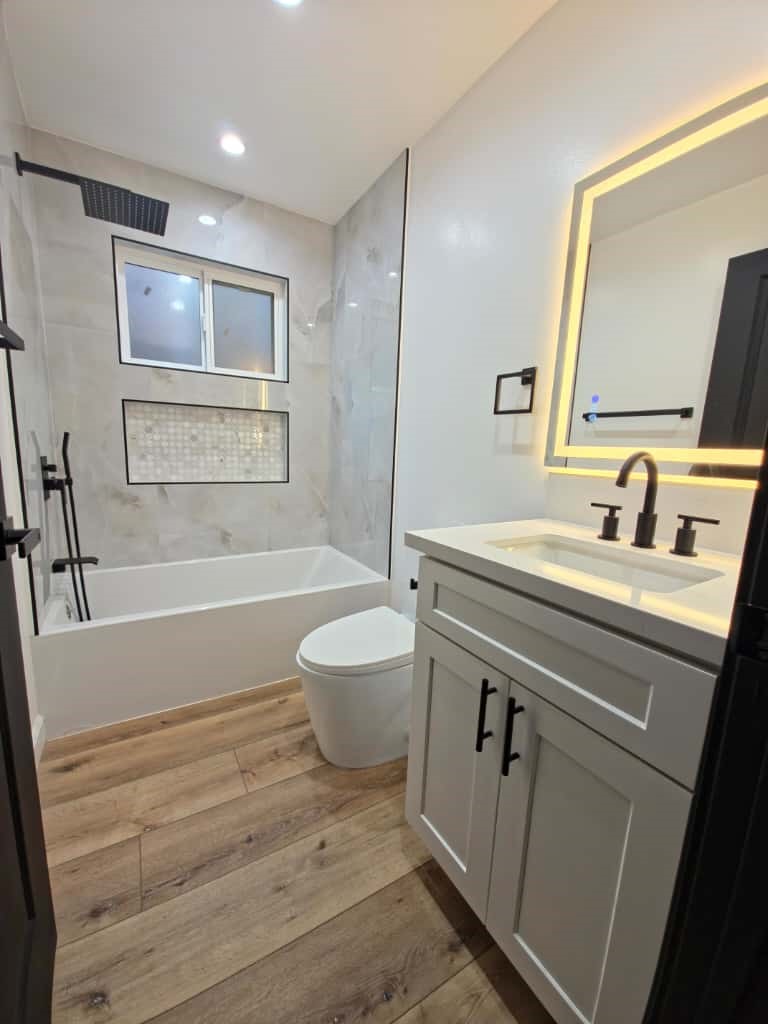 7045 Nestle Avenue Reseda, CA 91335 - Photo 7 of 15 a bathroom with a sink a toilet and shower