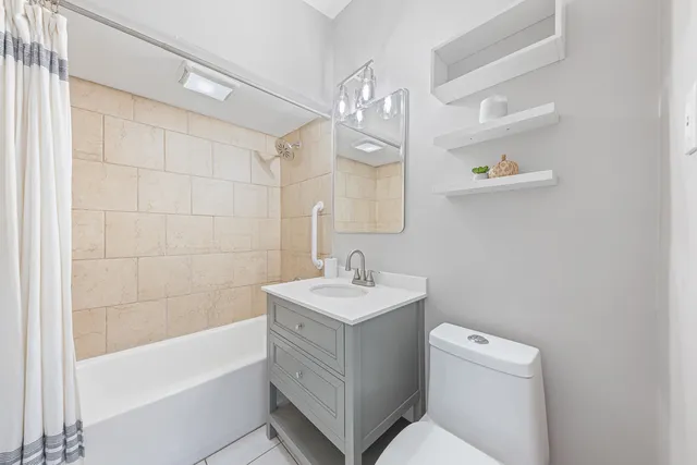 a bathroom with a sink a toilet and bathtub