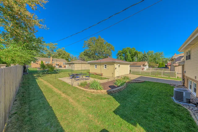 a view of an house with backyard space and seating area