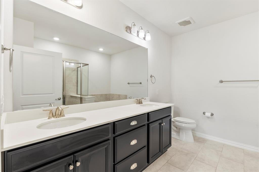 651 Watters Road, Unit 7202 Allen, TX 75013 - Photo 4 of 33 a bathroom with a double vanity sink toilet and a mirror