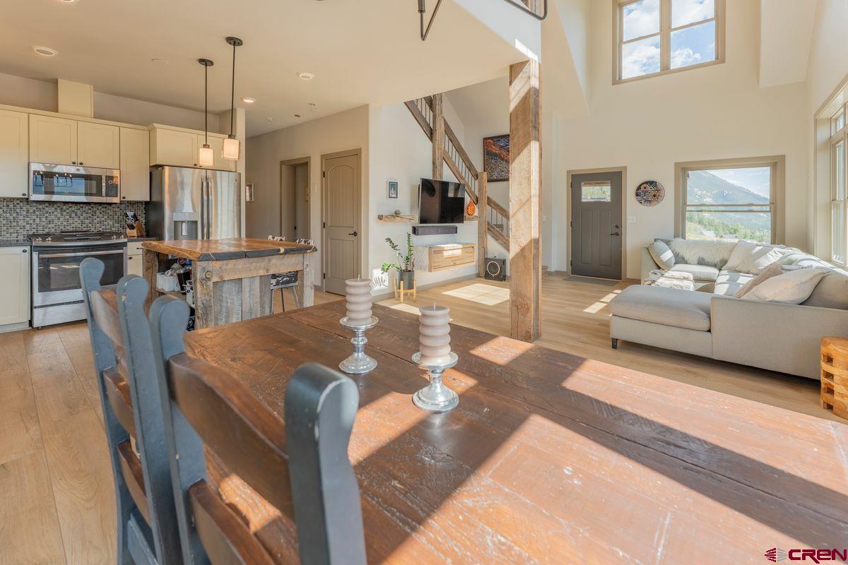 334 Anderson Drive Crested Butte, CO 81224 - Photo 14 of 45 a living room with kitchen island furniture and a chandelier