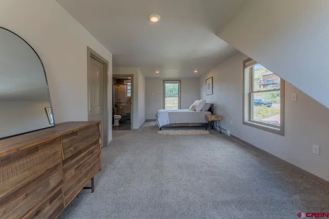 a bedroom with a bed and glass door