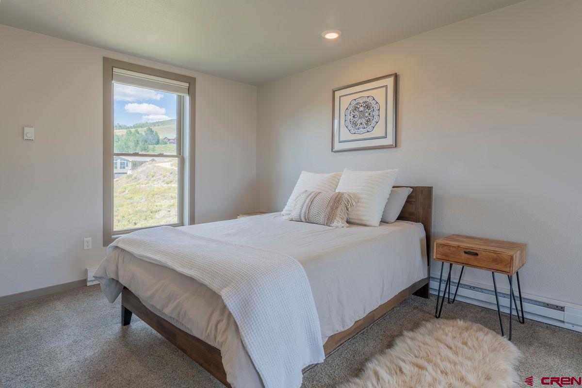 334 Anderson Drive Crested Butte, CO 81224 - Photo 22 of 45 a bedroom with a bed and a window