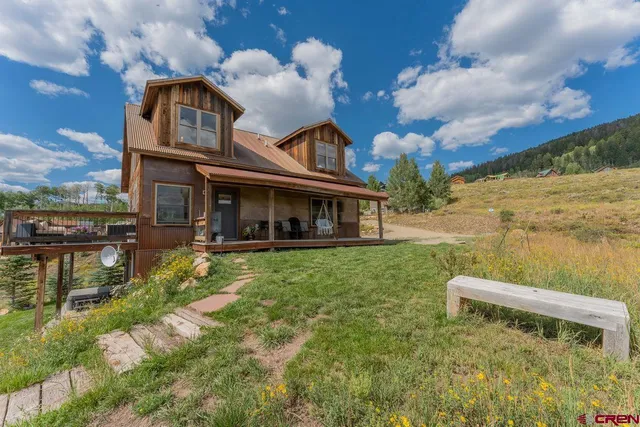 a view of a house with backyard porch and sitting area