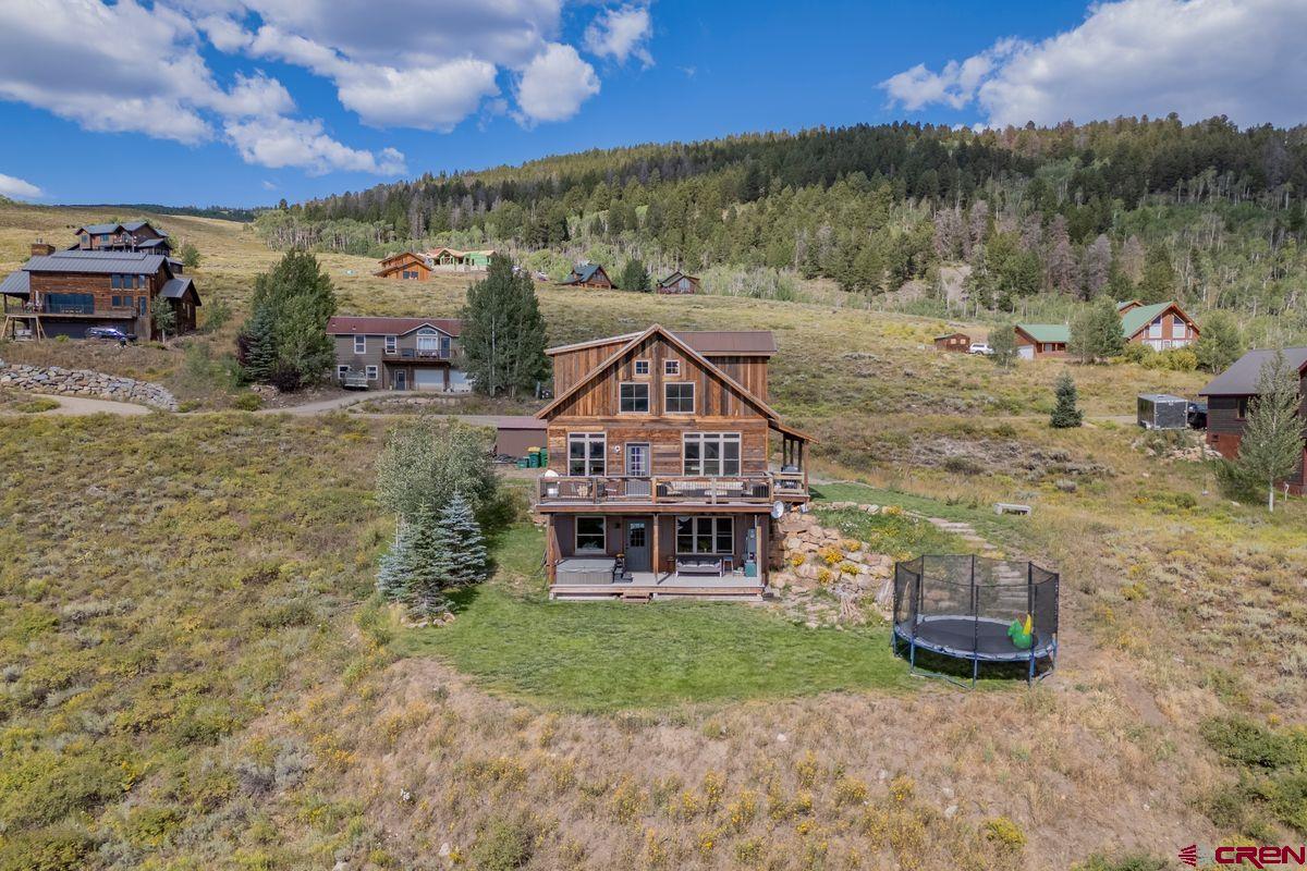 334 Anderson Drive Crested Butte, CO 81224 - Photo 41 of 45 a view of a house with a yard and a car park