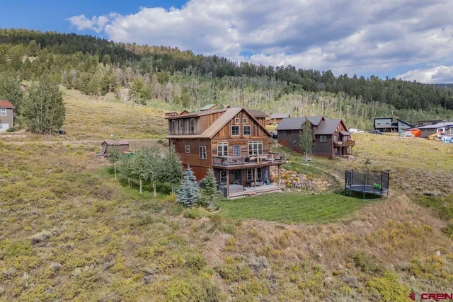 a aerial view of a house with a yard table and chairs
