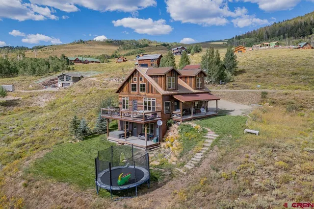 a view of a house with a yard from a terrace