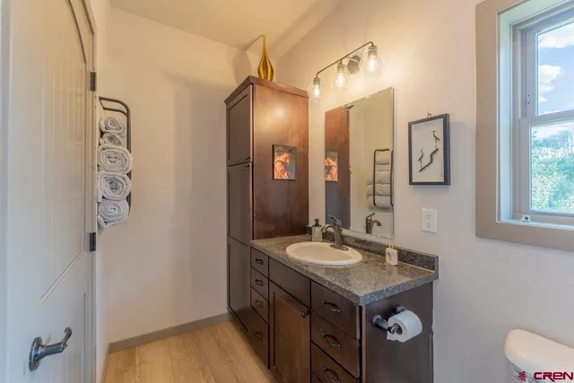 a bathroom with a sink vanity and a mirror