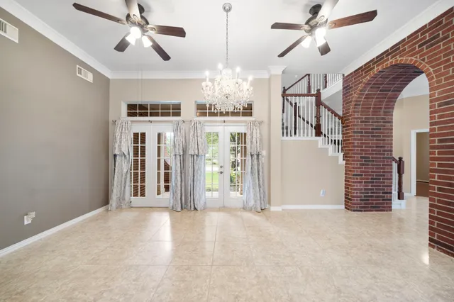 a view of a livingroom with a ceiling fan window and hardwood floor