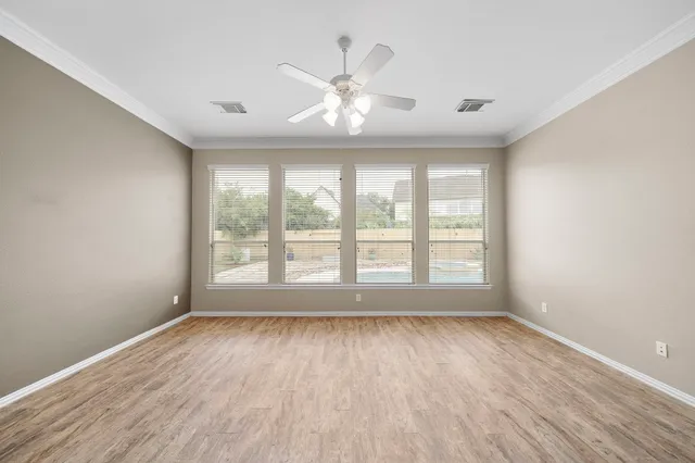 wooden floor in an empty room with a window