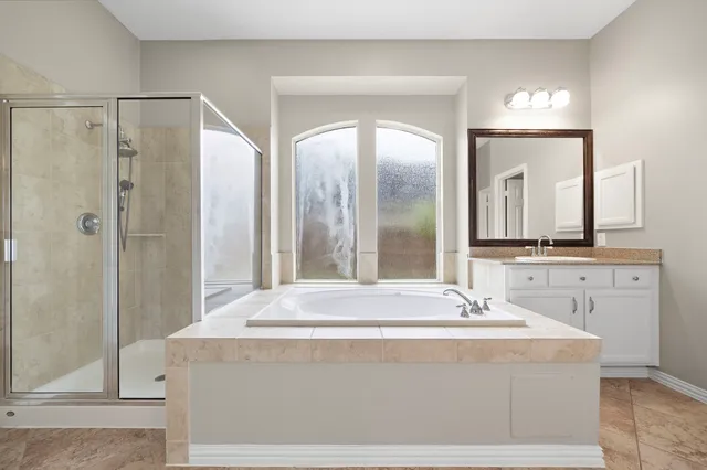 a bathroom with a double vanity sink mirror and shower