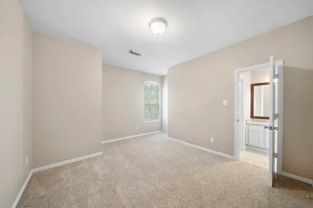 a view of an empty room and a window