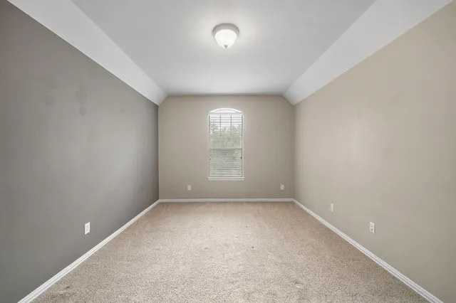 an empty room with a empty space and windows