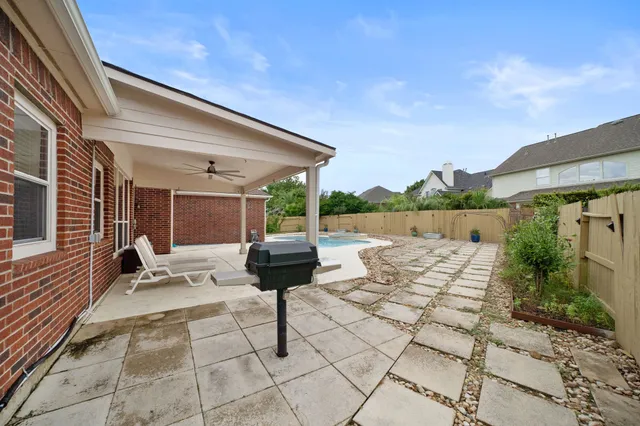 a backyard of a house with table and chairs