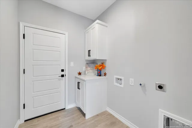 a white cabinet with an empty room