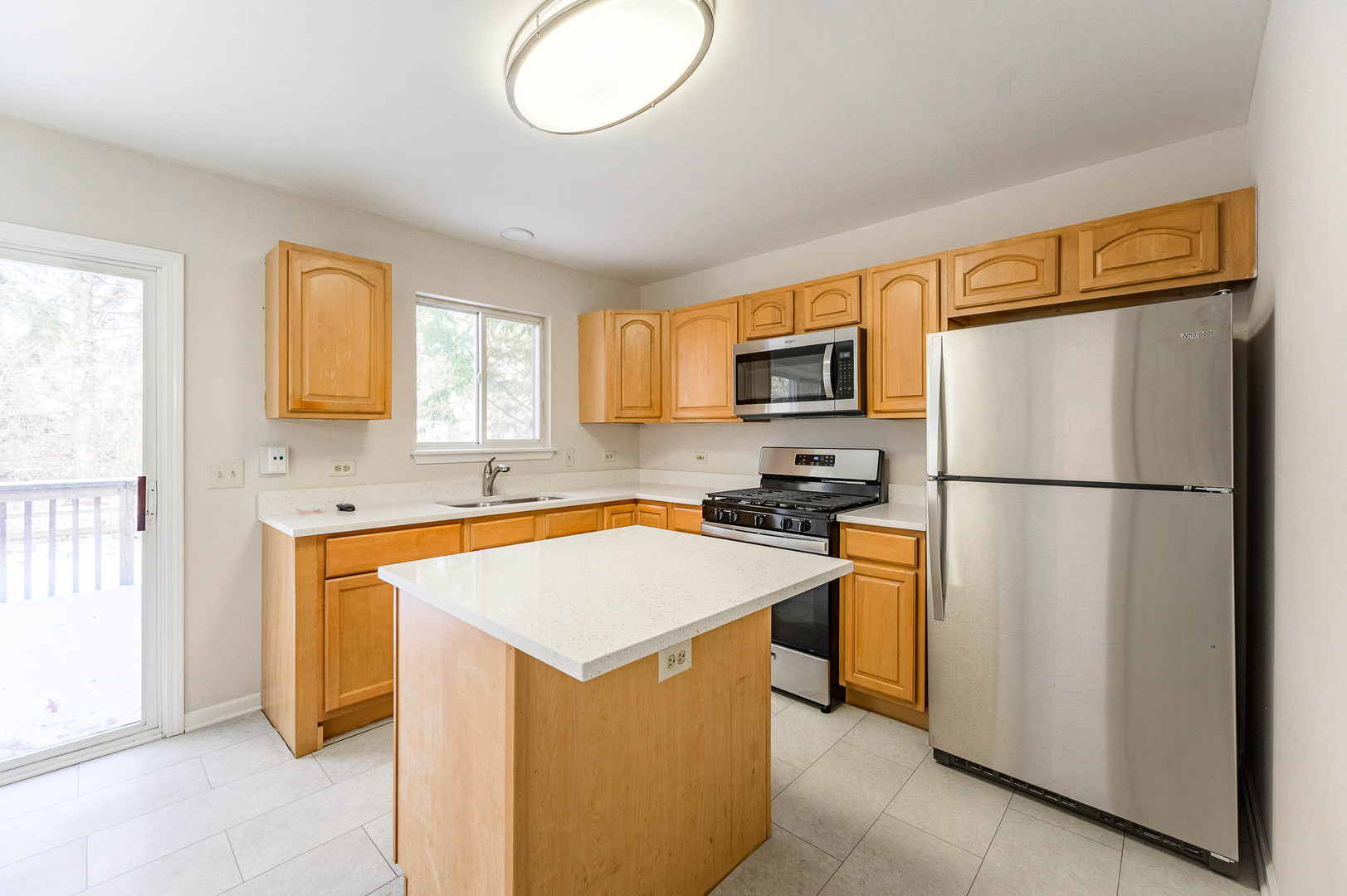2284 North Pheasant Ridge Court Round Lake Beach, IL 60073 - Photo 4 of 11 a kitchen with stainless steel appliances granite countertop a refrigerator a stove a sink dishwasher and a refrigerator