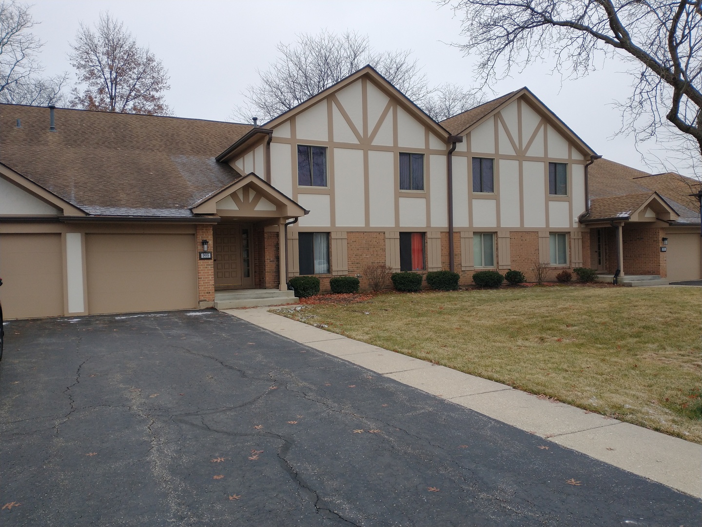 905 Surrey Drive, Unit 2B Schaumburg, IL 60193 - Photo 1 of 13 a view of a big house with a big yard and large tree