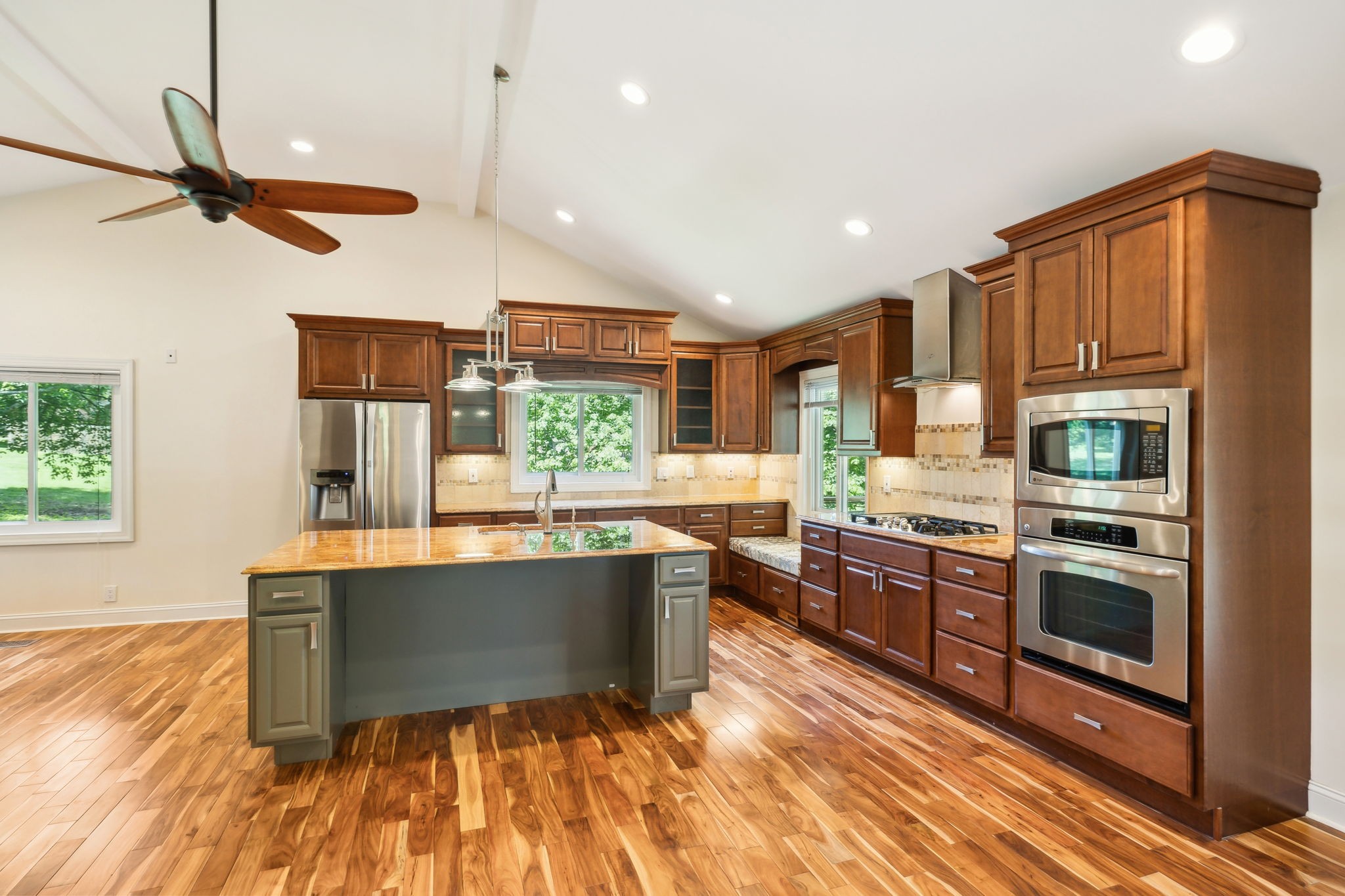 8166 Poplar Creek Road Nashville, TN 37221 - Photo 17 of 63 a kitchen with stainless steel appliances granite countertop a sink a stove and a wooden floors