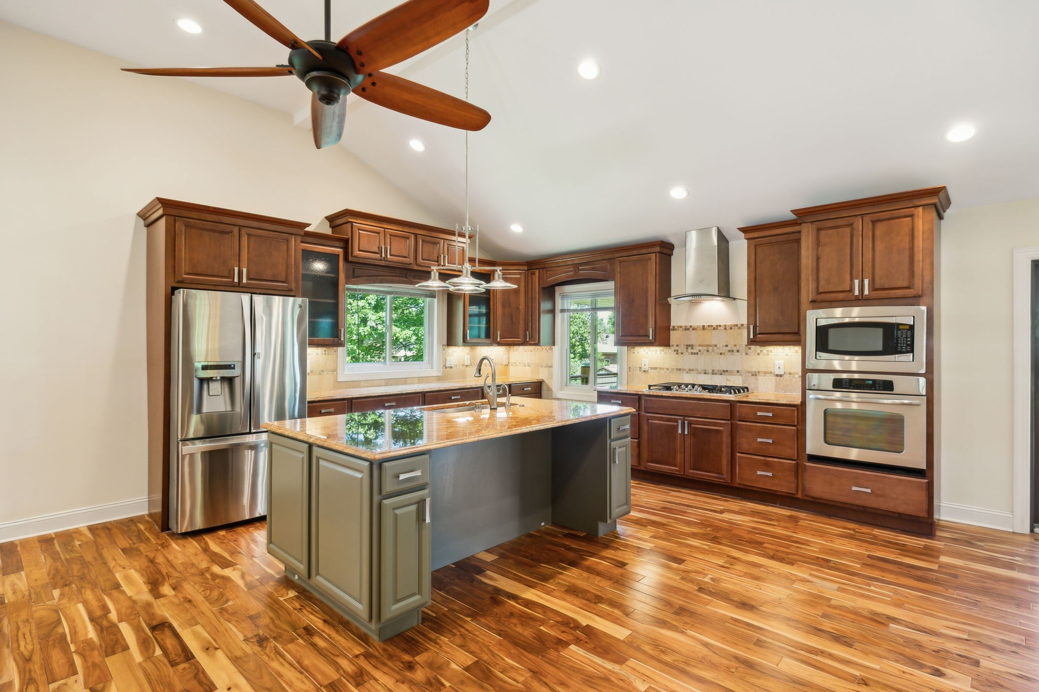 8166 Poplar Creek Road Nashville, TN 37221 - Photo 18 of 63 a kitchen with stainless steel appliances kitchen island granite countertop a refrigerator and a stove top oven