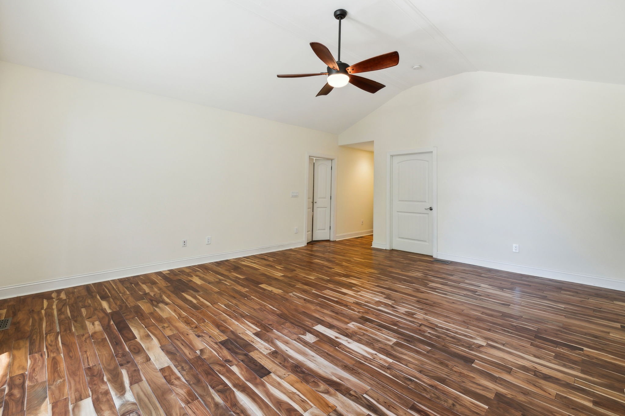 8166 Poplar Creek Road Nashville, TN 37221 - Photo 20 of 63 a view of a room with wooden floor and a ceiling fan