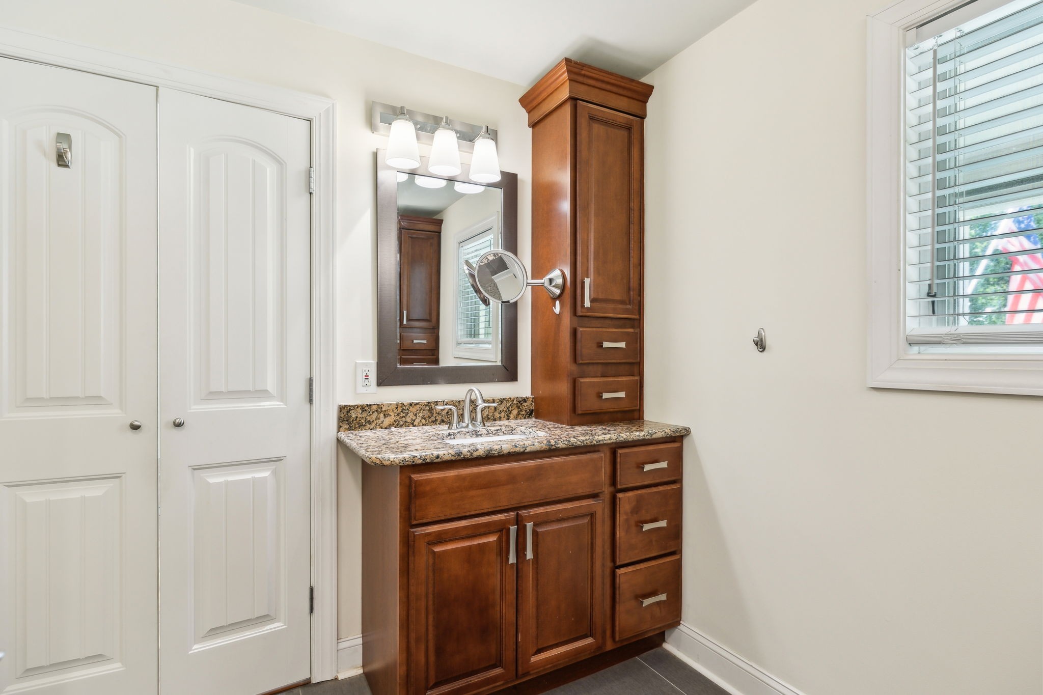 8166 Poplar Creek Road Nashville, TN 37221 - Photo 23 of 63 a bathroom with a sink vanity granite and a mirror