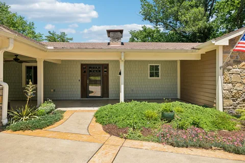 a view of a house with potted plants