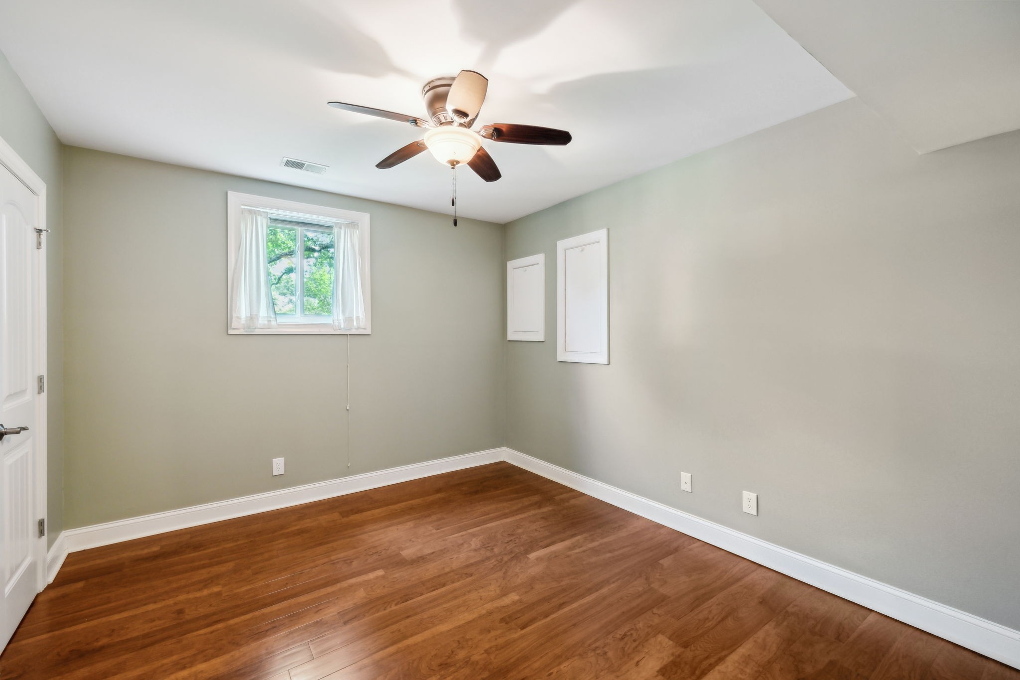 8166 Poplar Creek Road Nashville, TN 37221 - Photo 34 of 63 wooden floor in an empty room with a window