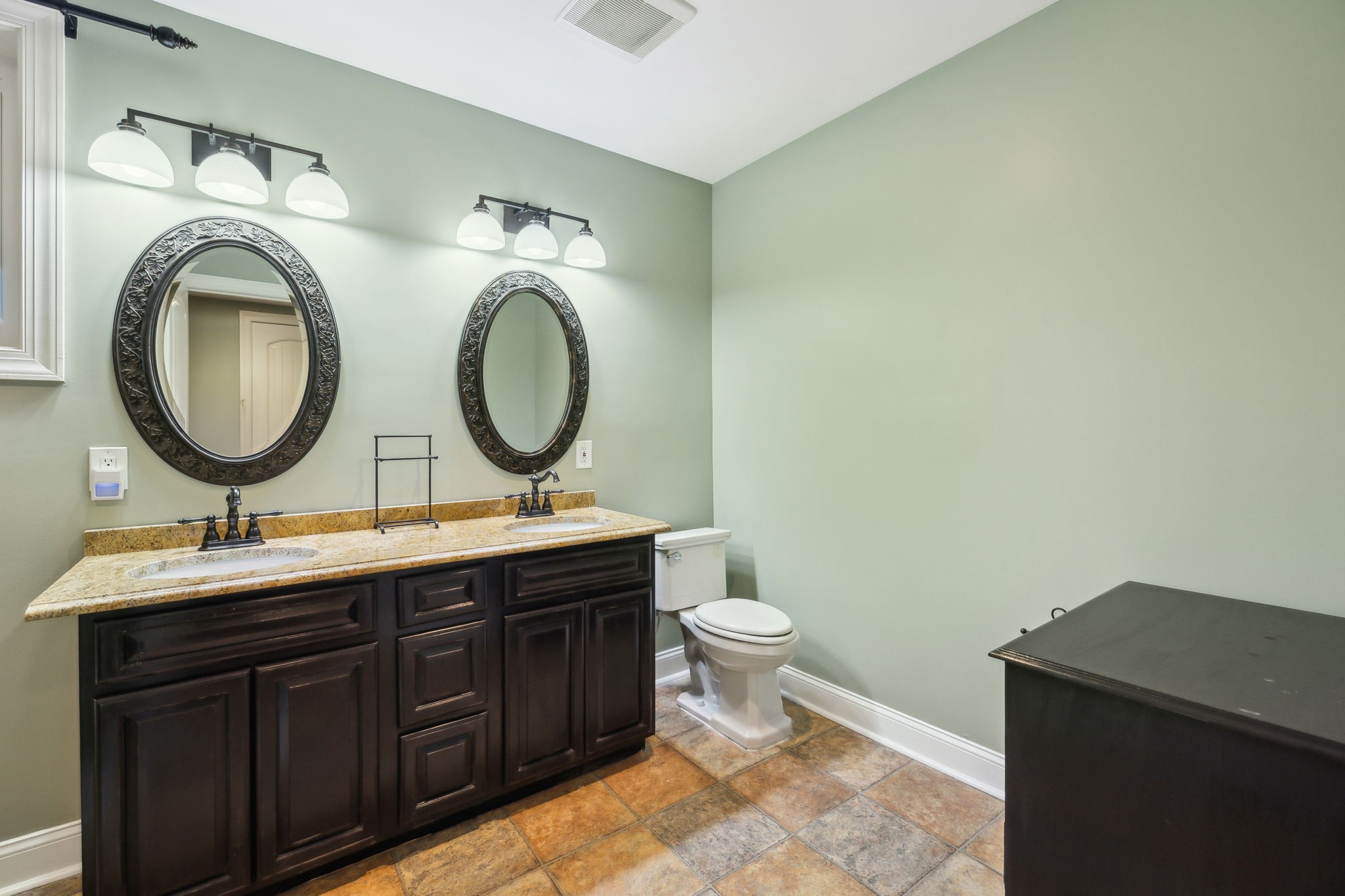 8166 Poplar Creek Road Nashville, TN 37221 - Photo 36 of 63 a bathroom with a toilet a sink and a mirror