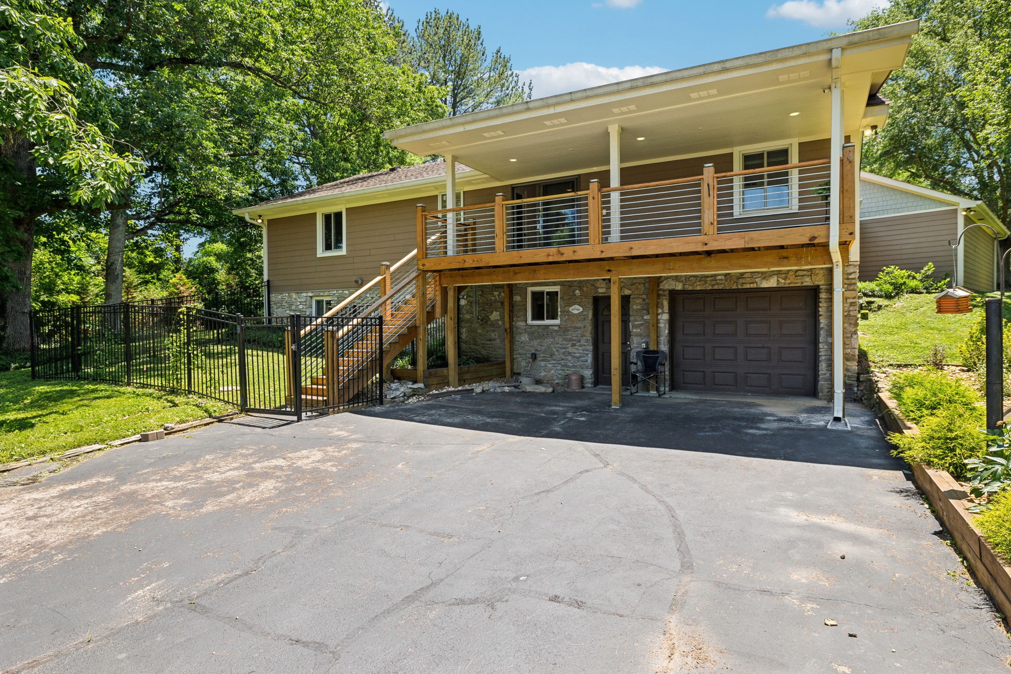 8166 Poplar Creek Road Nashville, TN 37221 - Photo 42 of 63 a front view of a house with a yard and garage