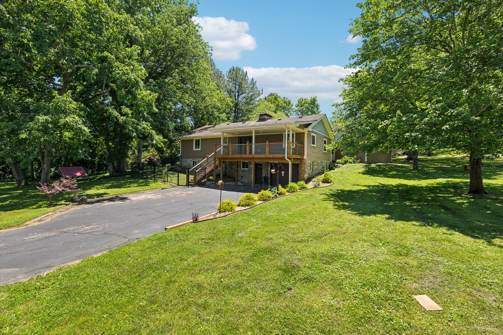 8166 Poplar Creek Road Nashville, TN 37221 - Photo 49 of 63 a view of a house with a yard porch and sitting area