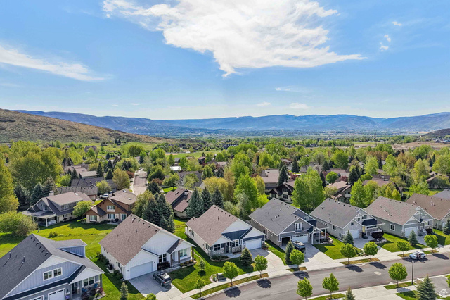 1238 Canyon View Road Midway, UT 84049 - Photo 34 of 36 Aerial perspective showcasing a residential neighborhood with varied architectural styles, mature trees, and landscaping