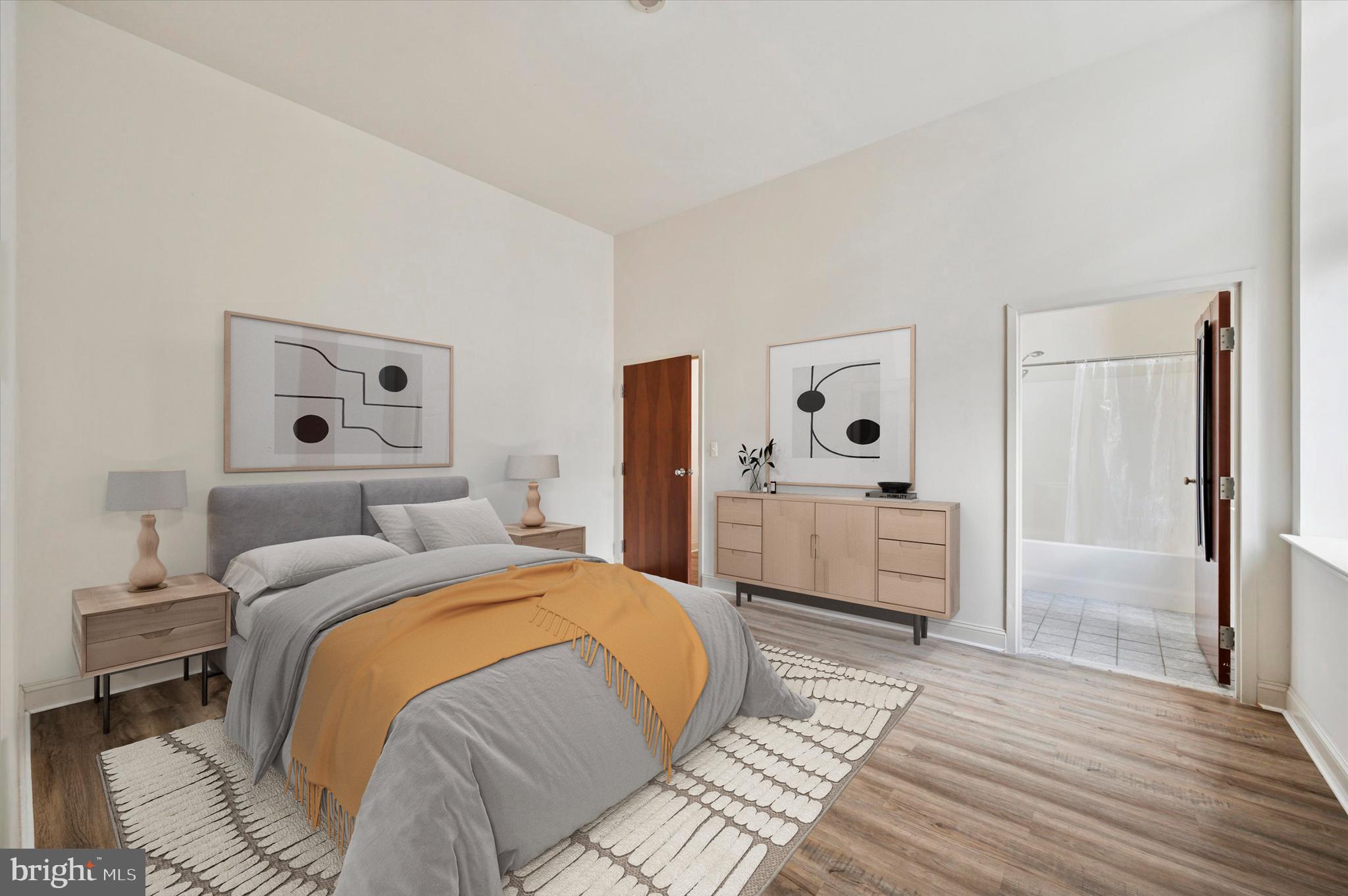 1001 Chestnut Street, Unit 904W Philadelphia, PA 19103 - Photo 12 of 25 a bedroom with a bed and a dresser