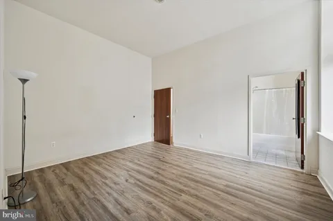 a view of an empty room with wooden floor