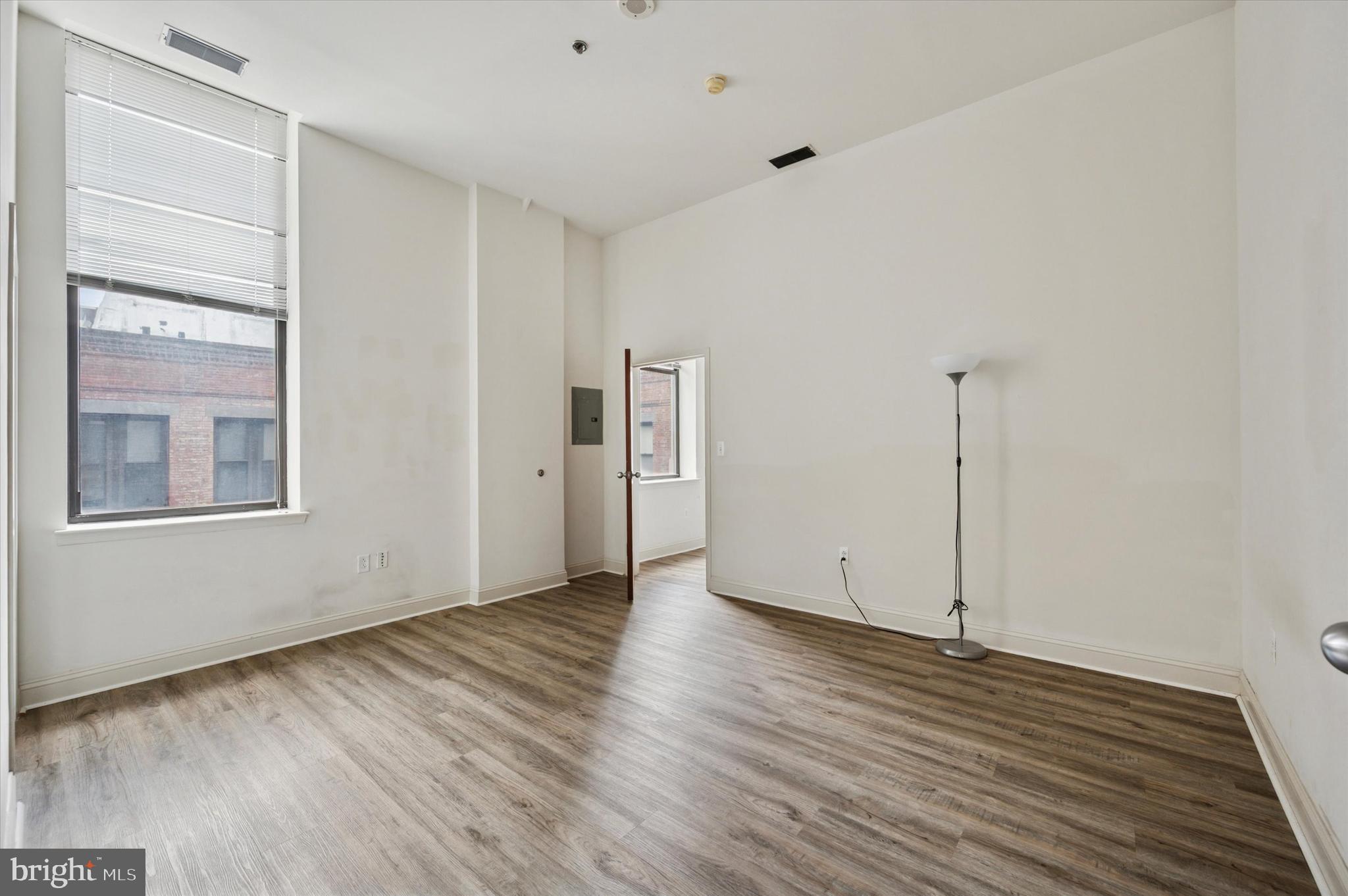 1001 Chestnut Street, Unit 904W Philadelphia, PA 19103 - Photo 15 of 25 a view of an empty room with wooden floor and a window