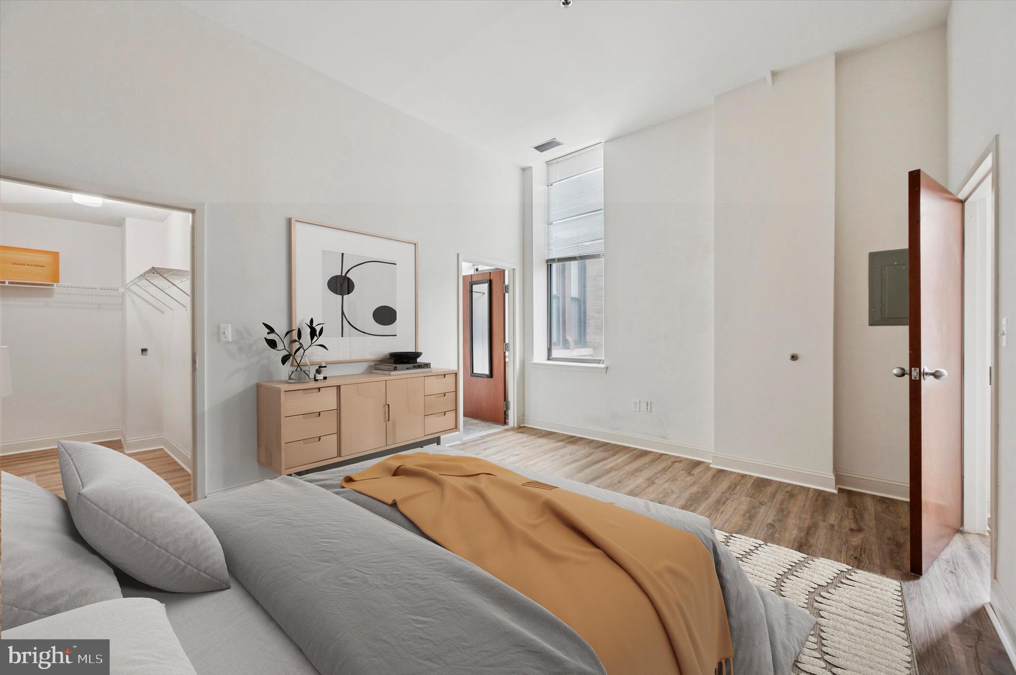 1001 Chestnut Street, Unit 904W Philadelphia, PA 19103 - Photo 18 of 25 a bedroom with a bed and a couch