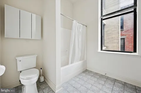 a bathroom with a toilet sink and tub