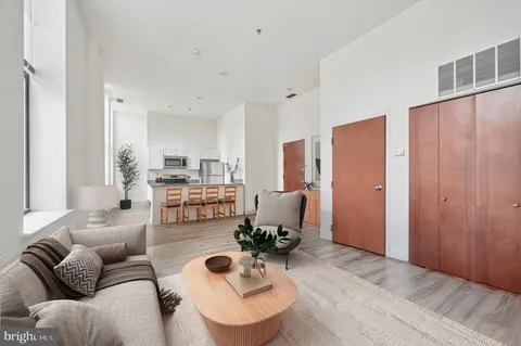 a living room with furniture and kitchen view