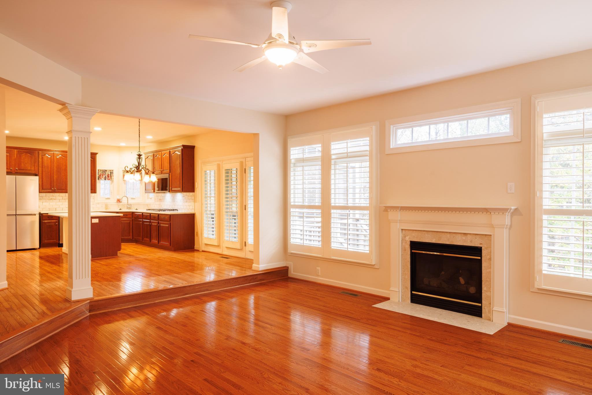 8623 James Creek Drive Springfield, VA 22152 - Photo 13 of 69 a view of a livingroom with a fireplace wooden floor and windows