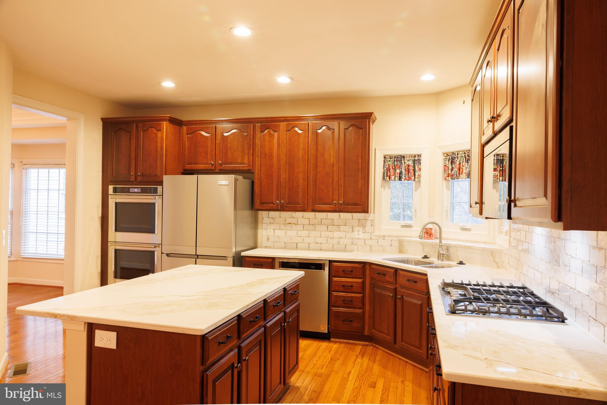8623 James Creek Drive Springfield, VA 22152 - Photo 19 of 69 a kitchen with stainless steel appliances granite countertop a sink a stove and a refrigerator