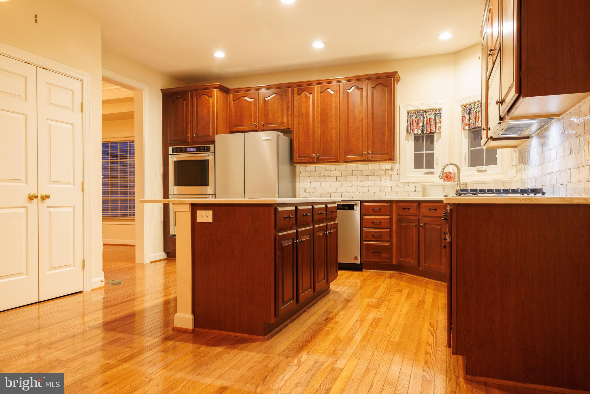 8623 James Creek Drive Springfield, VA 22152 - Photo 20 of 69 a kitchen with stainless steel appliances granite countertop a stove a sink and a refrigerator