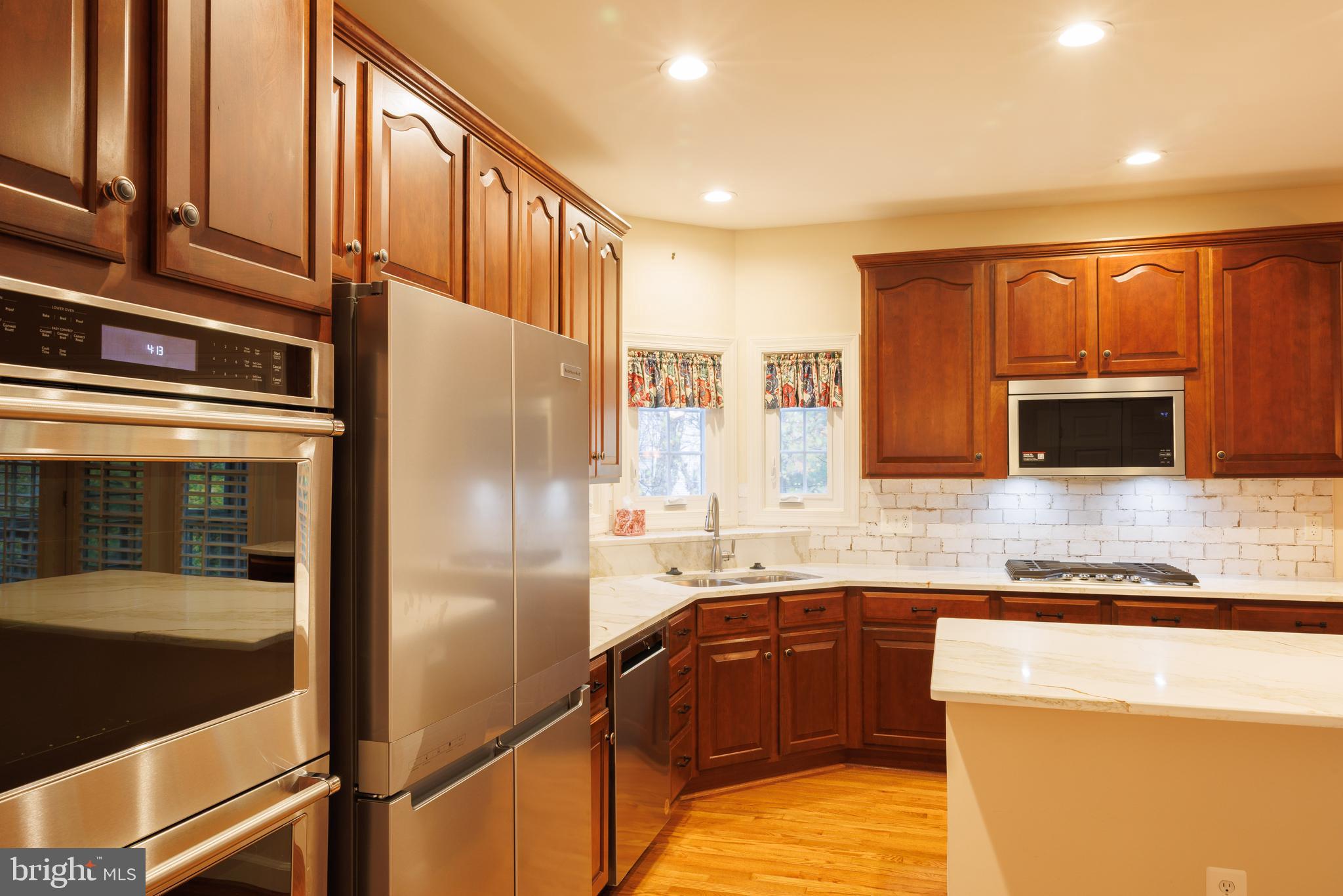 8623 James Creek Drive Springfield, VA 22152 - Photo 21 of 69 a kitchen with stainless steel appliances granite countertop a refrigerator and a sink