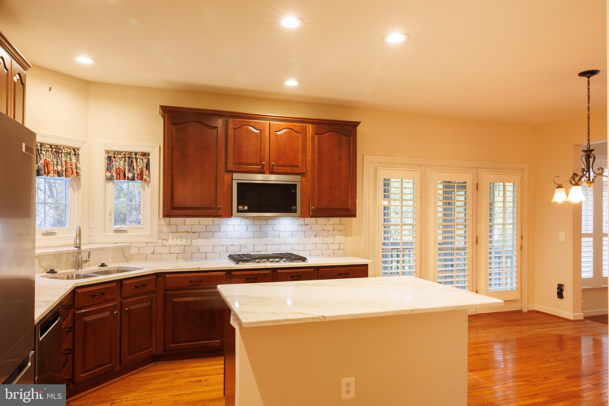 8623 James Creek Drive Springfield, VA 22152 - Photo 22 of 69 a kitchen with stainless steel appliances granite countertop a sink a stove and a microwave oven