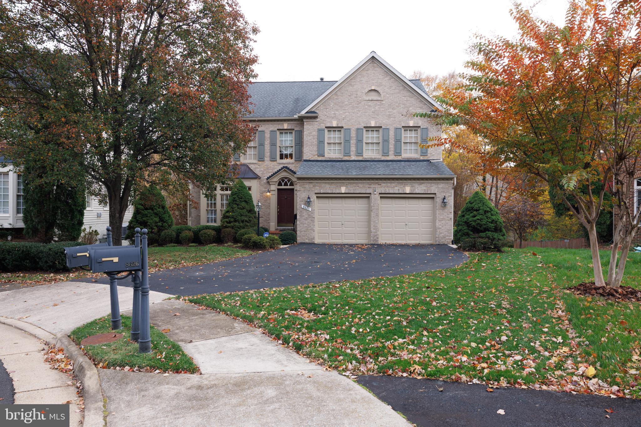 8623 James Creek Drive Springfield, VA 22152 - Photo 5 of 69 a front view of a house with a yard and garage